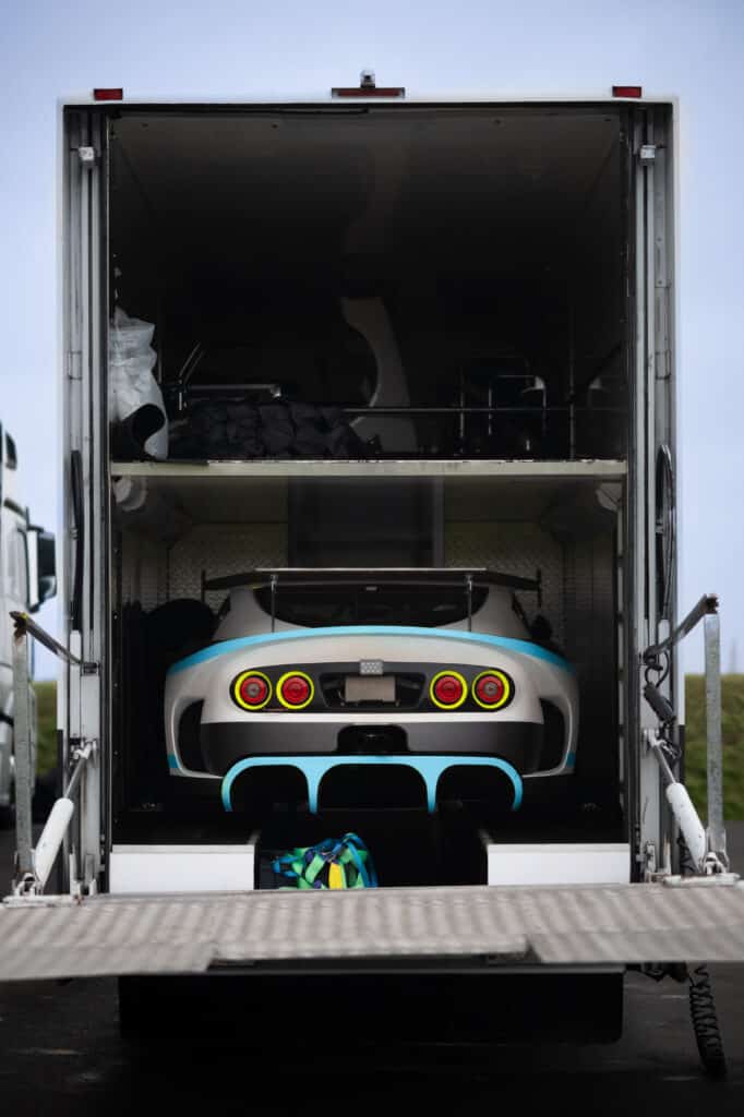 motorsport support vehicle transporter truck transporting motorsport race car to event